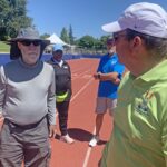 Jeff Davison (left) consults with Bill Murray while marking track for shuttle hurdles relay.