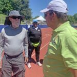 Jeff Davison (left) consults with Bill Murray while marking track for shuttle hurdles relay. P