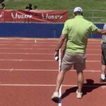 Bill Murray pats Jeff Davison while marking track for shuttle hurdles relay.