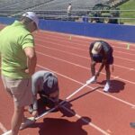 Games Committee member Bill Murray watches start line places for 80-meter events.