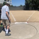 USATF field referee checks out shot put ring at American River College.