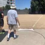 USATF field referee checks out shot put ring at American River College.